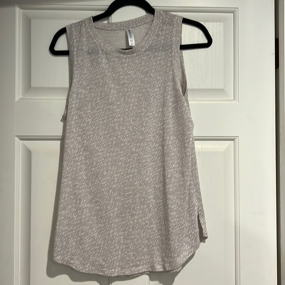 Flowy tank top. Khaki stripe detail. Material more on the sheer side